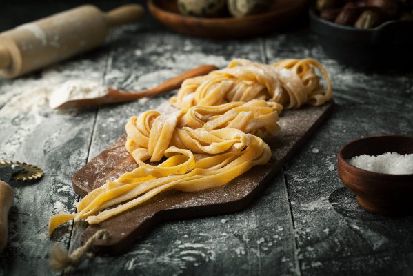 Pasta and ingredients on a dark background